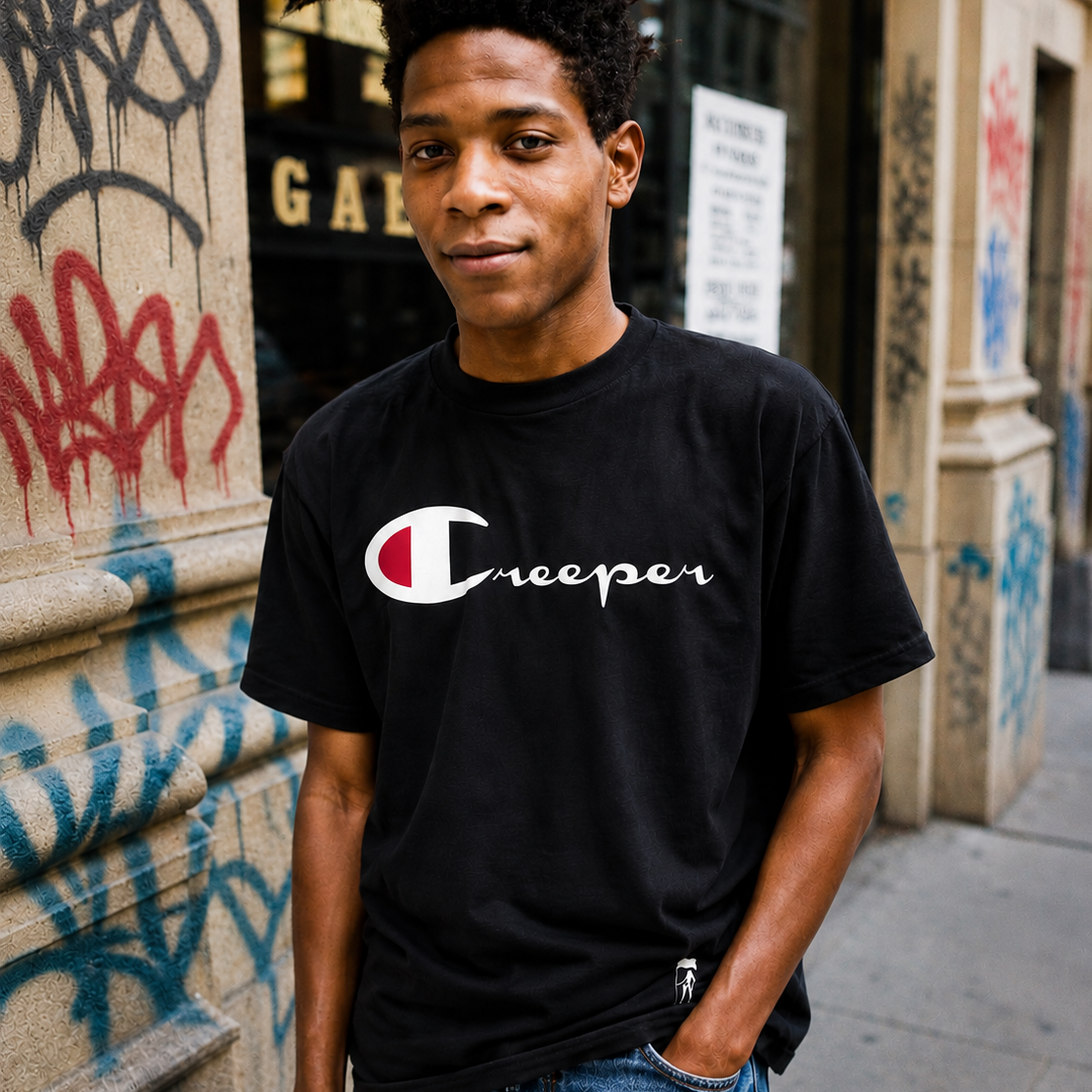 Black CREEPER Champ Tee for men, 100% combed cotton, with white and red "Creeper" logo.