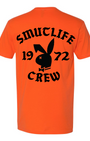 Men's tangerine cotton t-shirt with black "SMUTLIFE 1972 CREW" text and bunny logo.