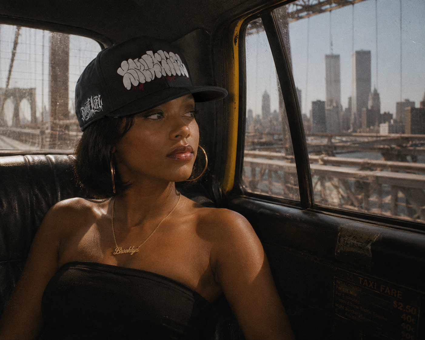 Woman in a black SMUTLIFE THROWIE 6-panel snapback hat, looking out a taxi window at the NYC skyline.