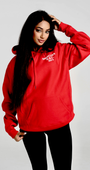 Woman wearing a red SMUTLIFE 1972 N.Y.C. unisex hoodie with a front pouch pocket.