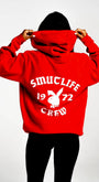 Red SMUTLIFE 1972 N.Y.C. unisex hoodie with white graphic print and Playboy bunny logo on back.