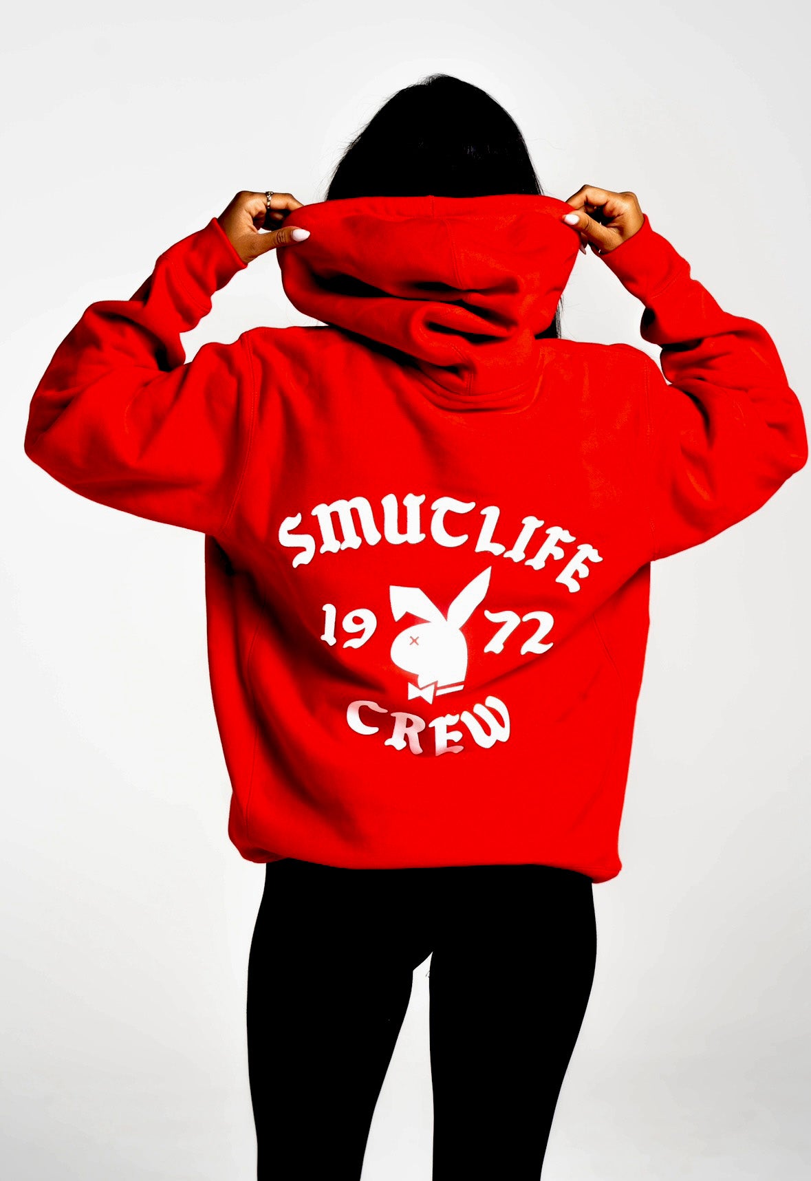 Red SMUTLIFE 1972 N.Y.C. unisex hoodie with white graphic print and Playboy bunny logo on back.