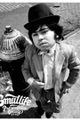 Black and white image of Hervé Villechaize (Tattoo) in a pinstripe suit and bowler hat, standing by a hydrant.