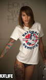 Woman in white SMUTLIFE Natural Remedies Boyfriend T-shirt with pin-up girl design, black underwear, and tattoos.